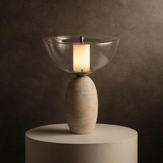 Decorative lamp with glass shade and stone base on a round platform against a dark background