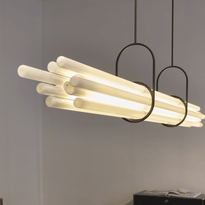 Modern pendant light with cylindrical bulbs on a gray background