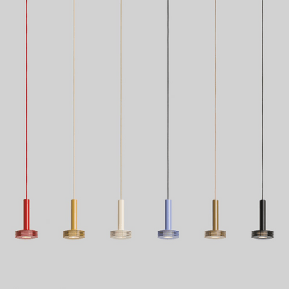 Five pendant lights in different colors hanging against a gray background