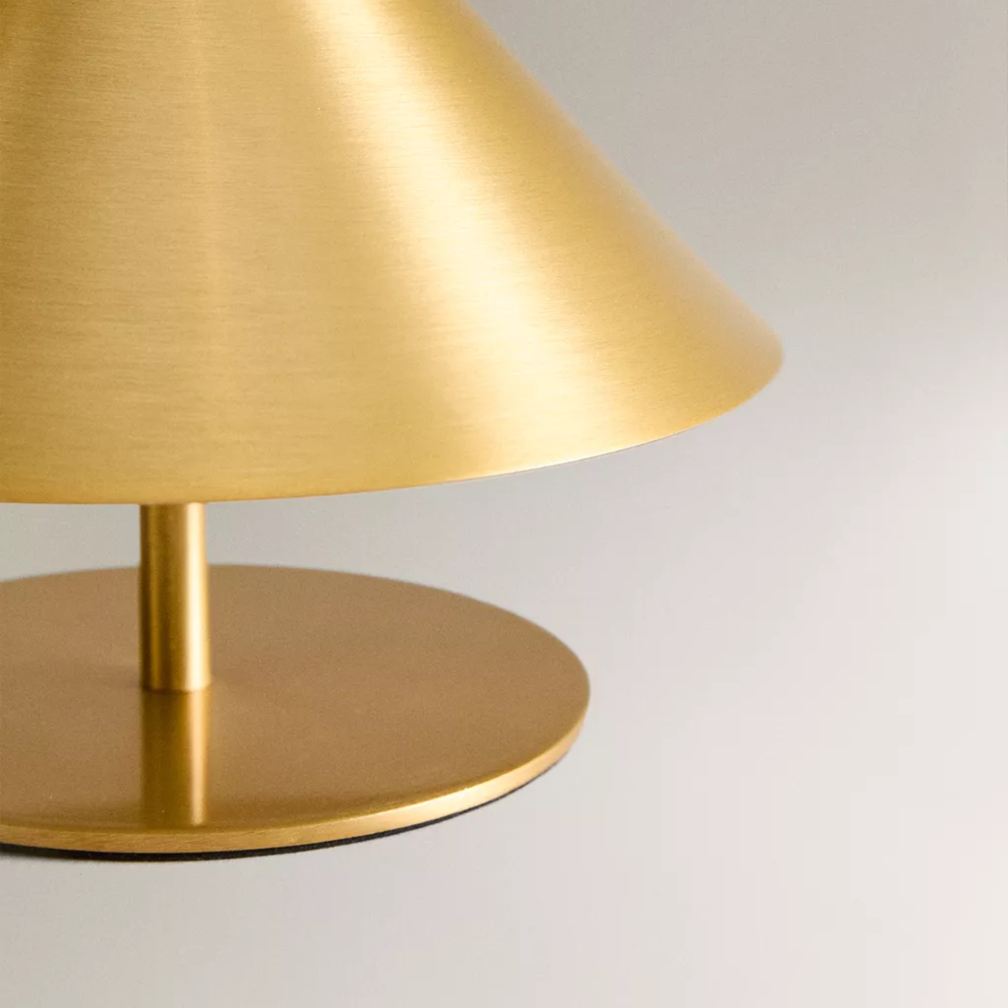 Gold table lamp on a light gray background