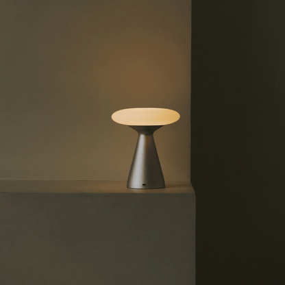 Modern table lamp with a round shade on a dark background