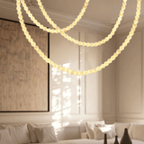 String lights hanging in a living room with a couch and artwork.