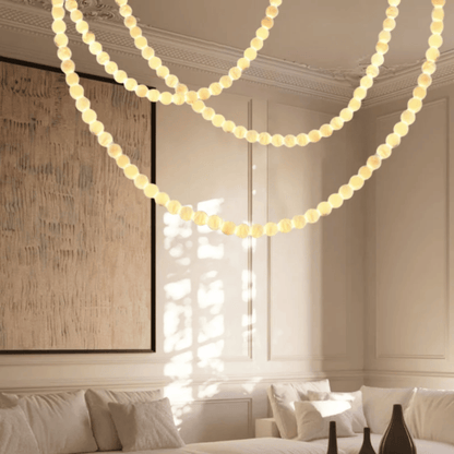 String lights hanging in a living room with a couch and artwork.