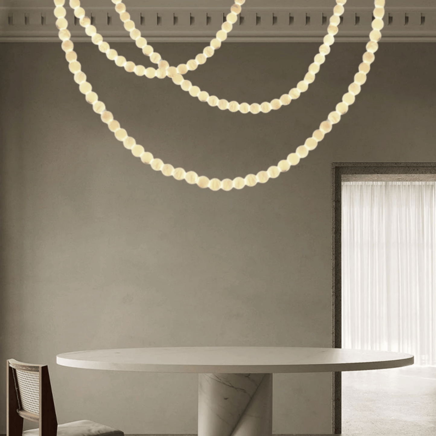 Modern dining room with a round marble table and pendant lights.