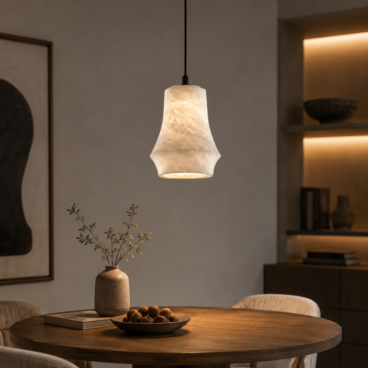 Pendant light fixture hanging above a wooden table with decorative items in a cozy room.