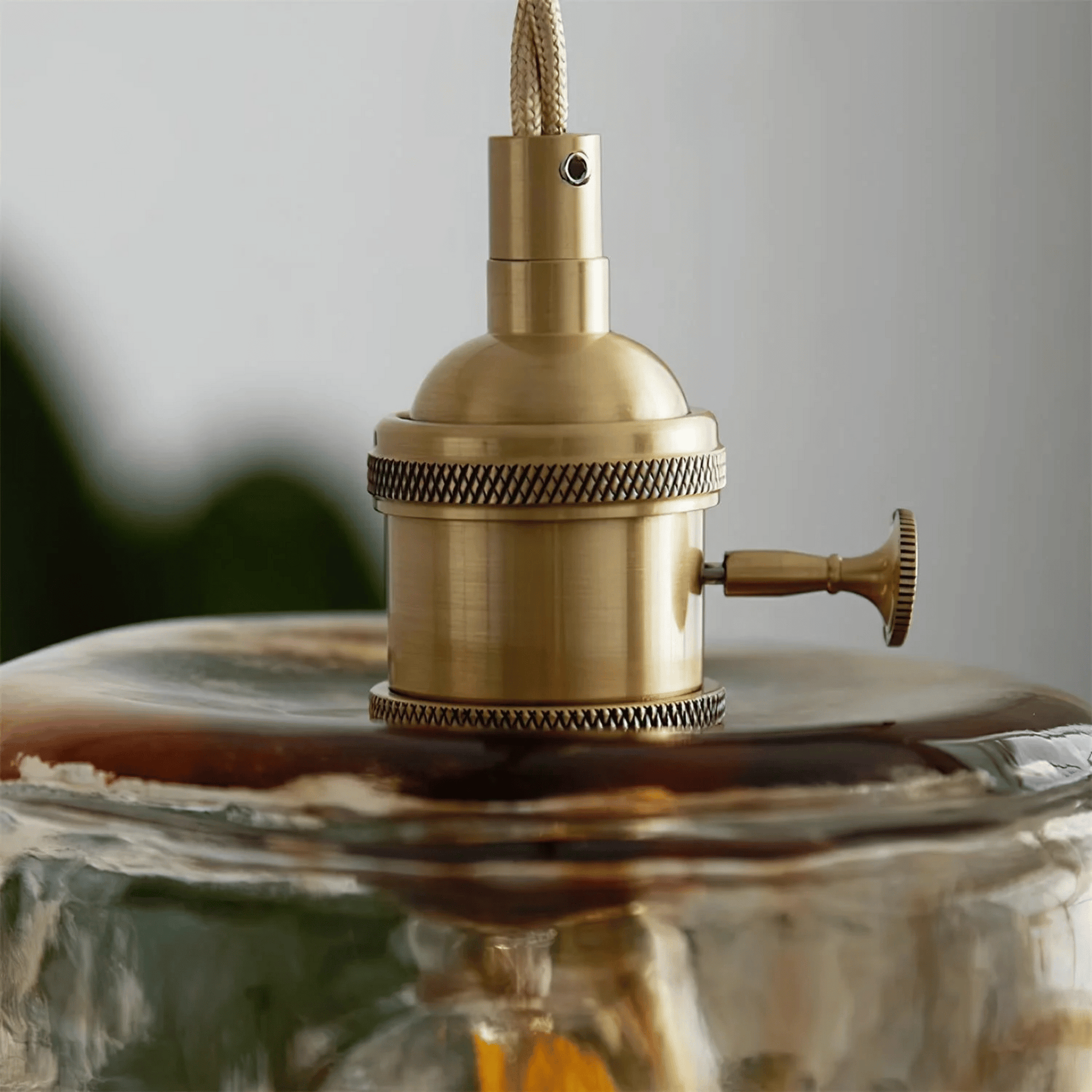 Brass lampshade with glass diffuser on a neutral background