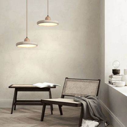 Modern interior with a table, chair, and pendant lights in a neutral setting