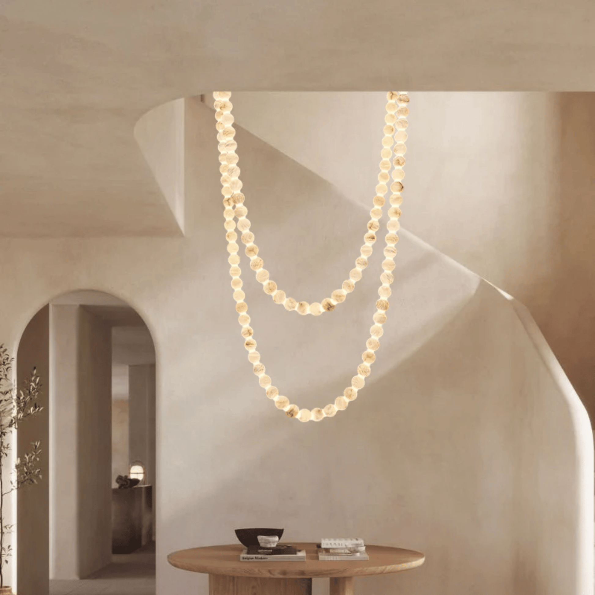 Pearl necklace hanging from a ceiling in a modern interior setting