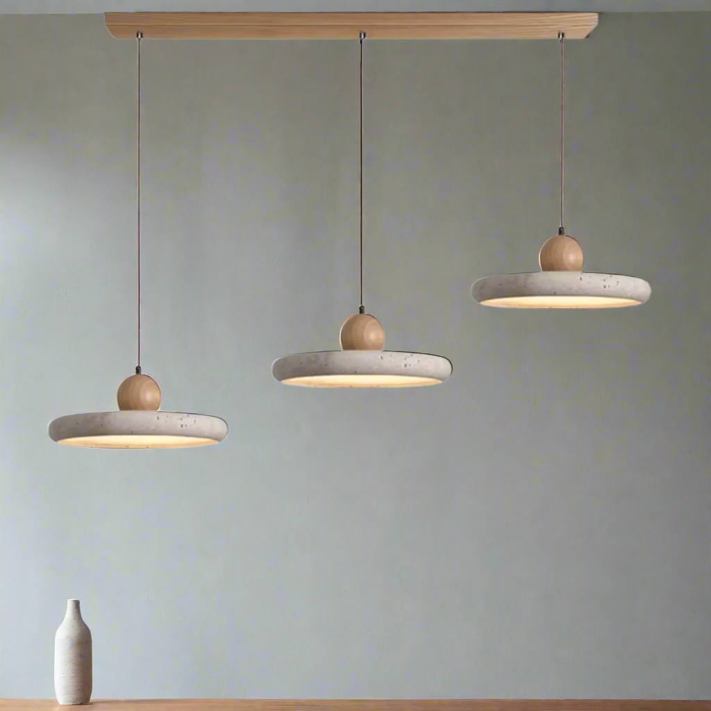 Three concrete pendant lights with wooden knobs on a white background