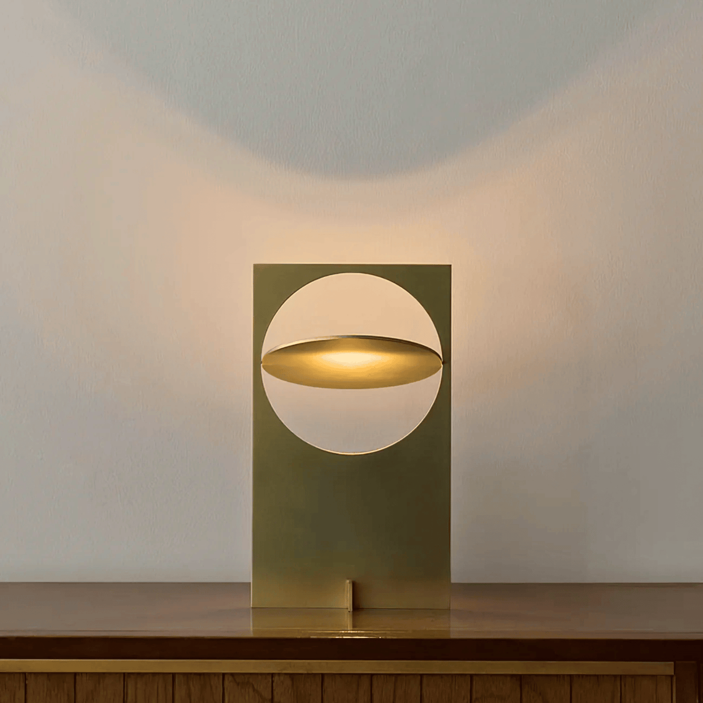 Modern table lamp with a geometric design on a wooden surface.