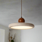 Pendant light with concrete shade and wooden bulb holder on a gray background