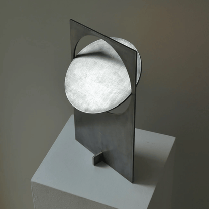 Modern wall lamp with a spherical light bulb on a gray background