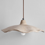 Concrete pendant light with a wavy design on a gray background