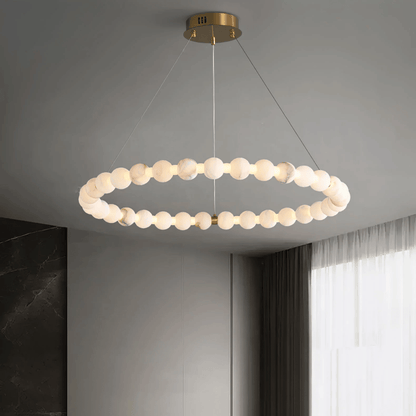 Modern pendant light fixture hanging from the ceiling in a room with a window.