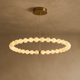 Modern chandelier with circular design on a beige background
