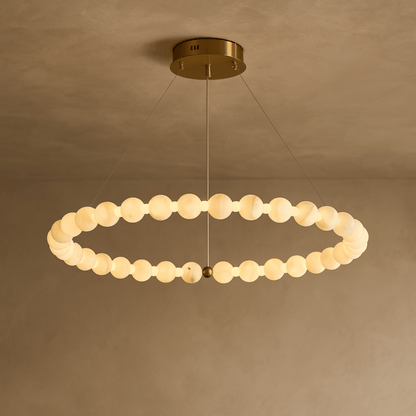 Modern chandelier with circular design on a beige background