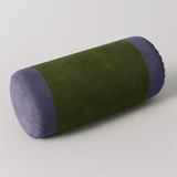 Green and purple cylindrical pillow on a light gray background