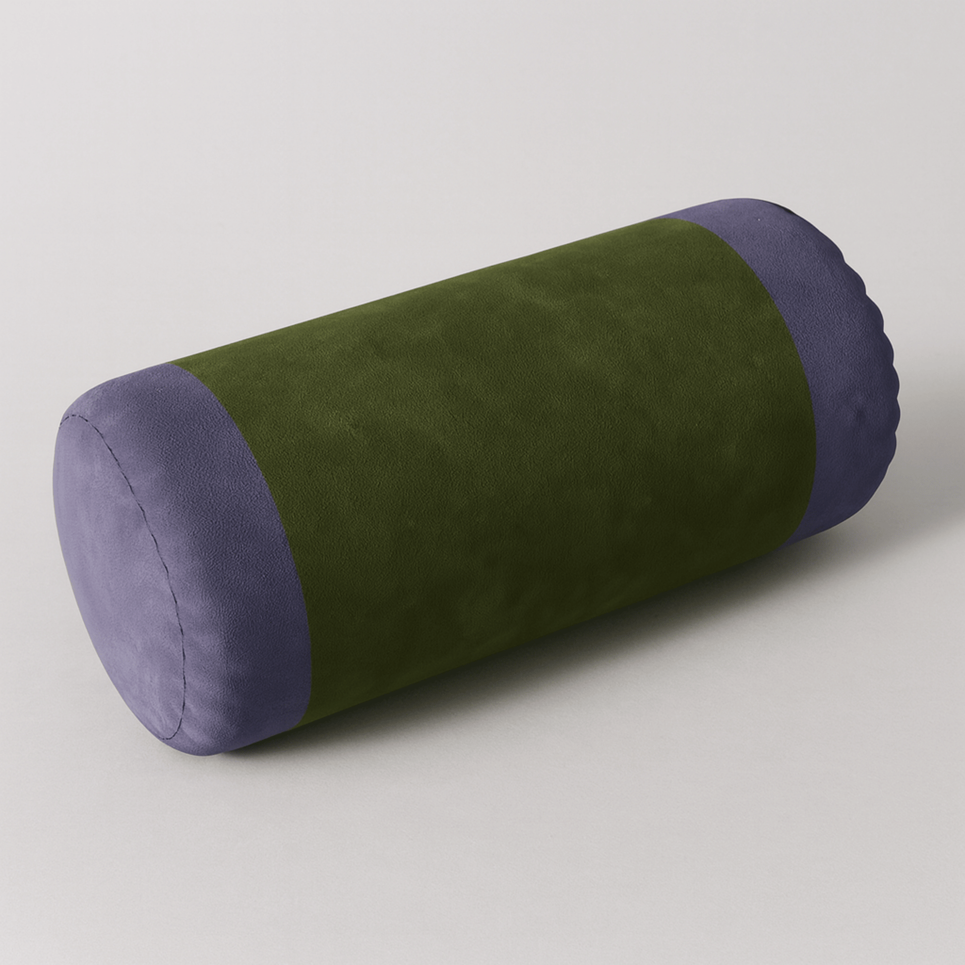Green and purple cylindrical pillow on a light gray background