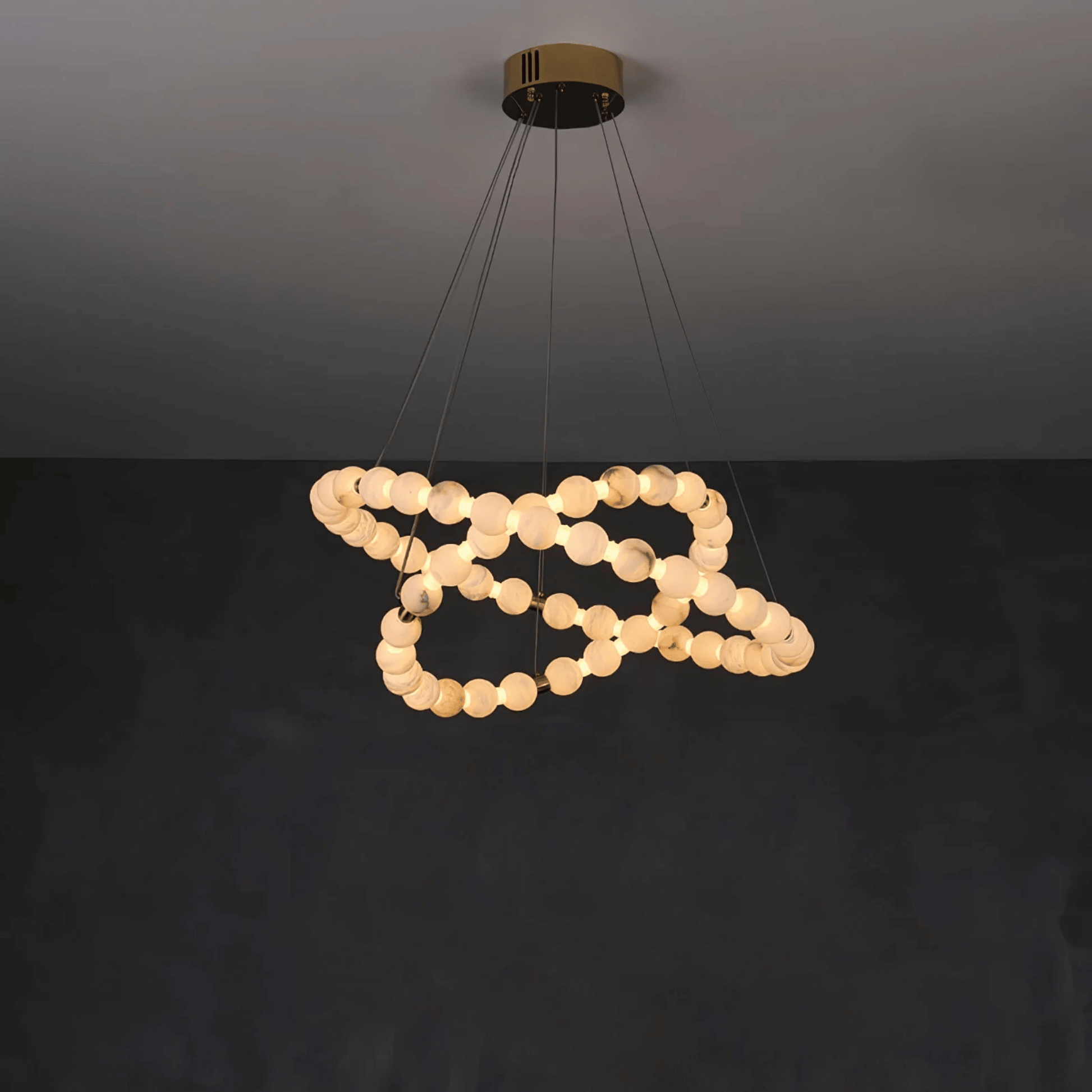 Modern pendant light with circular bulbs on a dark background