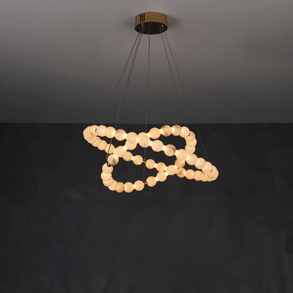 Modern pendant light with circular bulbs on a dark background