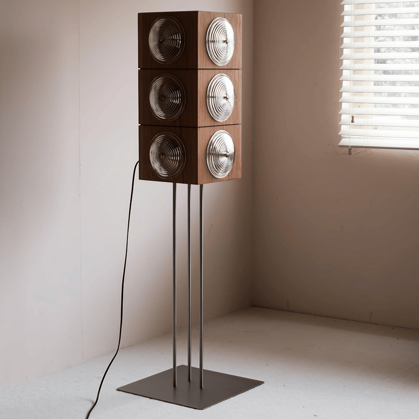Wooden speaker system on a stand in a minimalistic room with a window.