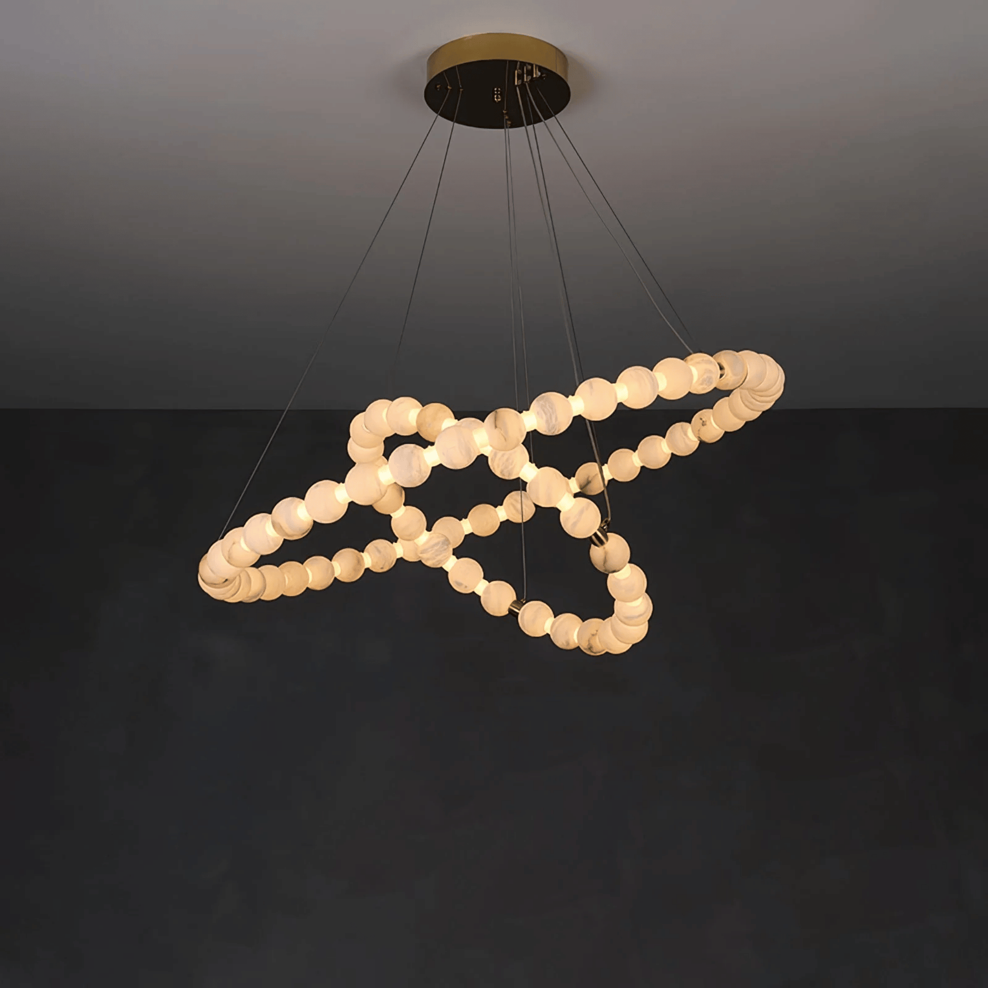 Modern chandelier with circular design on a dark background