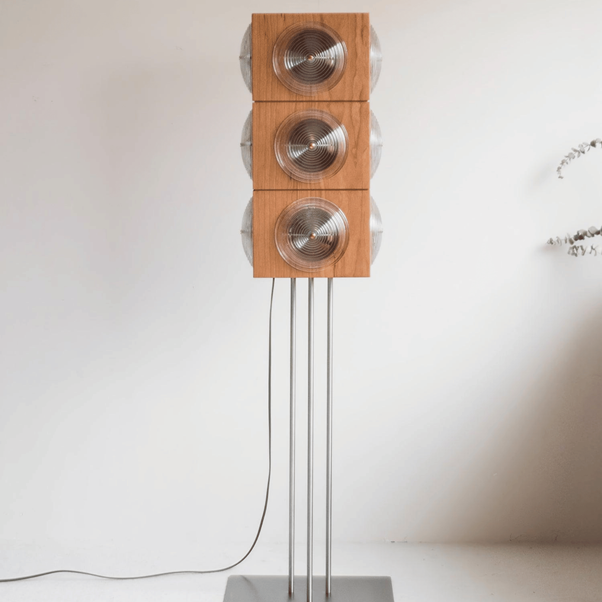 Wooden speaker system with metallic elements on a white background