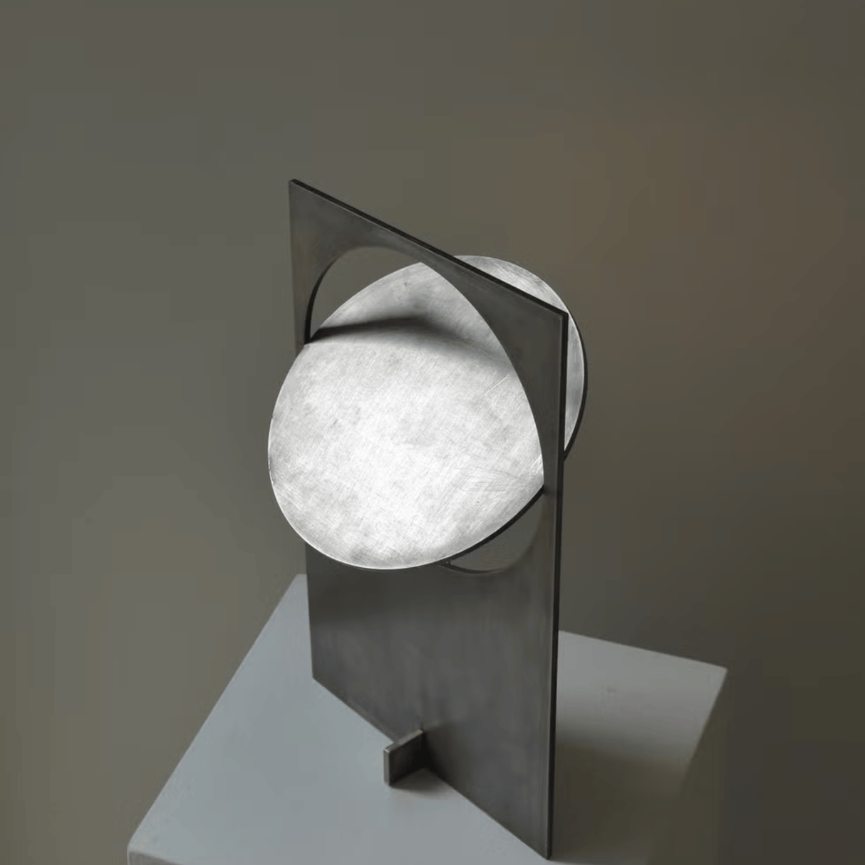 Modern wall light fixture with a geometric design on a neutral background