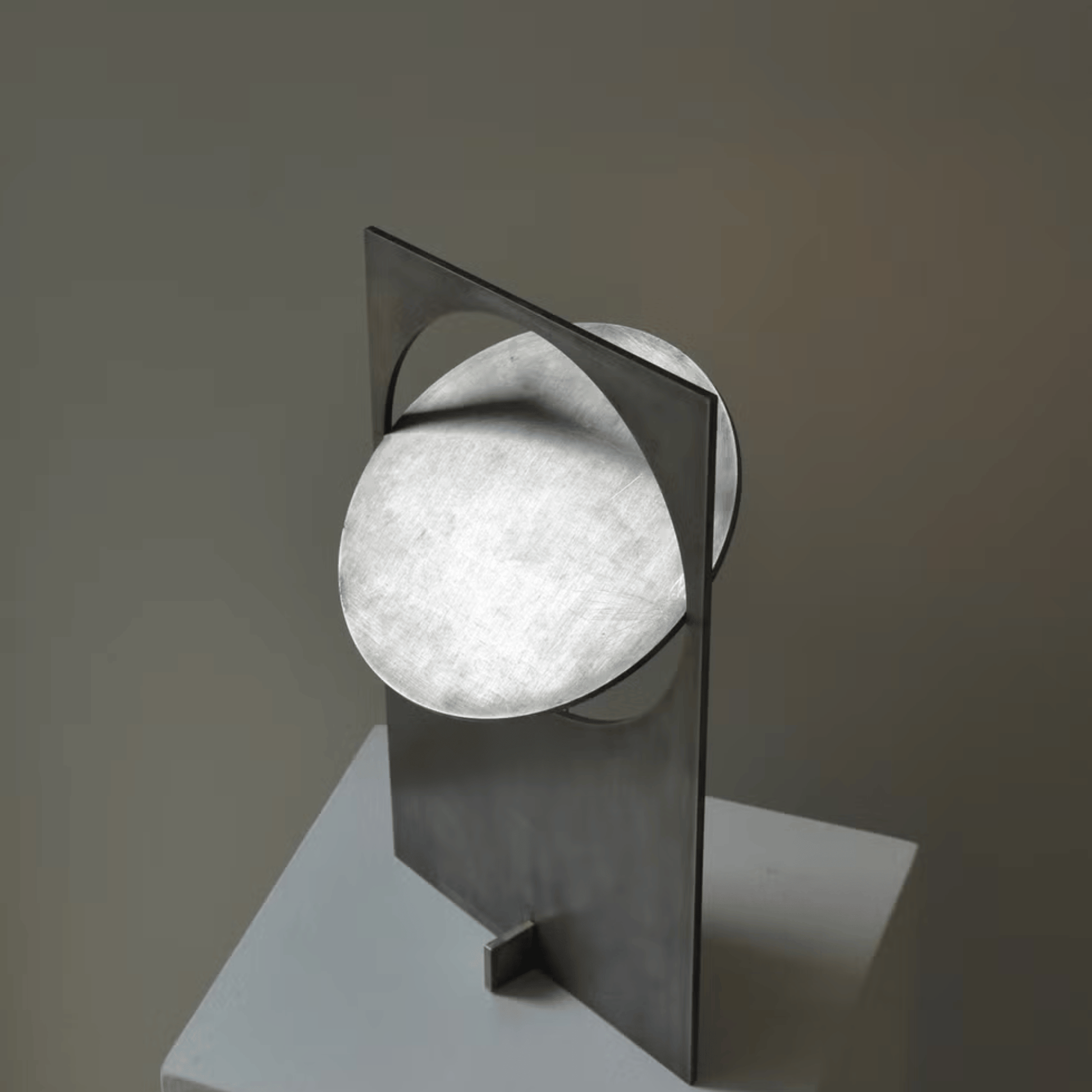 Modern wall light fixture with a geometric design on a neutral background