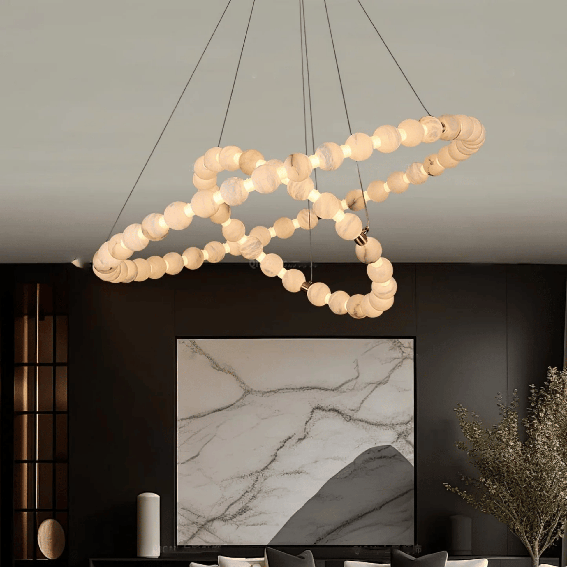 Modern chandelier with circular light bulbs in a living room setting.