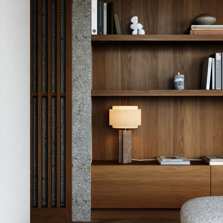 Wooden bookshelf with a lamp and decorative items in a room setting.