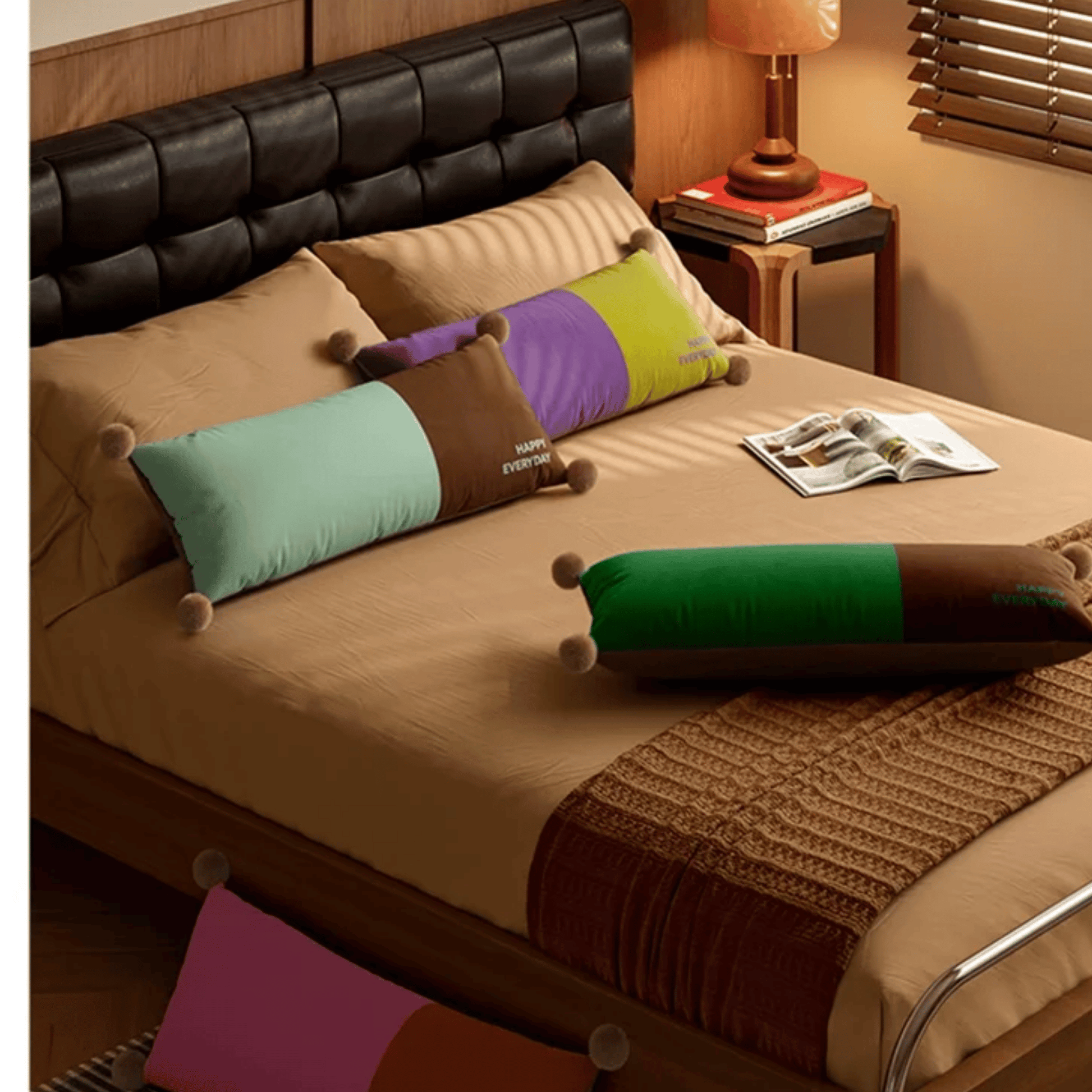 Bed with colorful pillows and a magazine on a wooden nightstand.