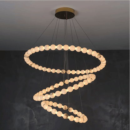 Modern chandelier with circular design on a dark background