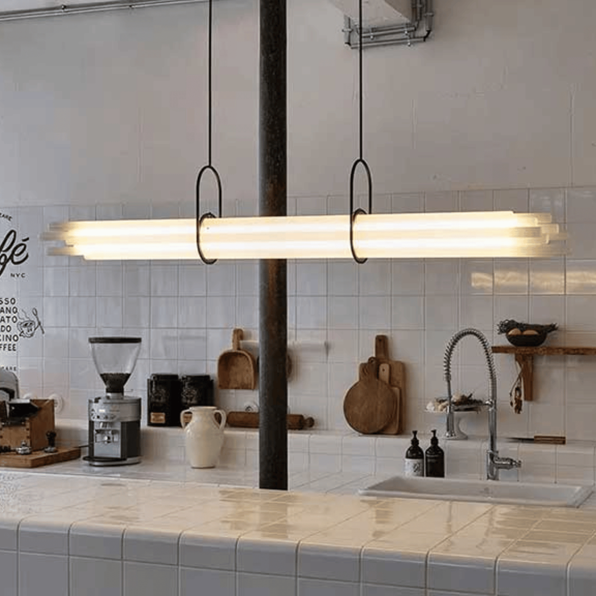Modern kitchen with a long linear pendant light fixture.
