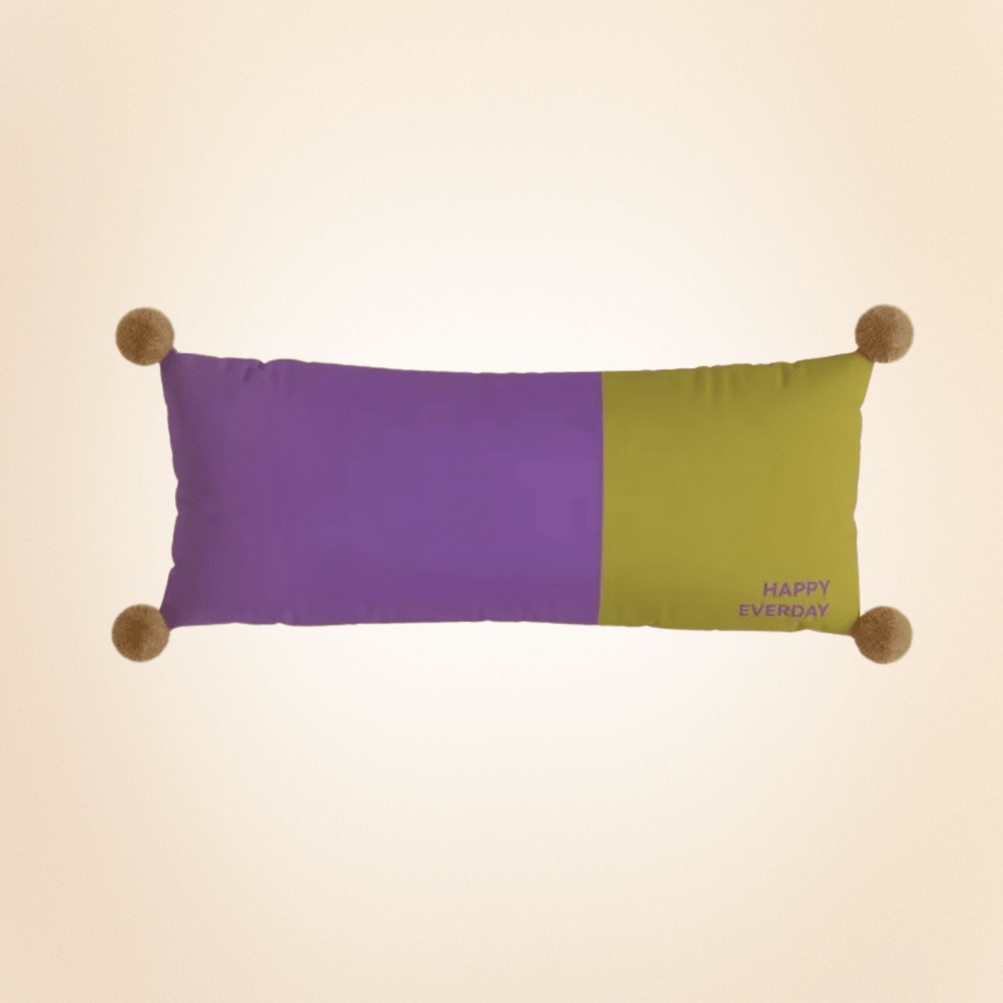 Color-blocked pillow with purple and green sections on a beige background