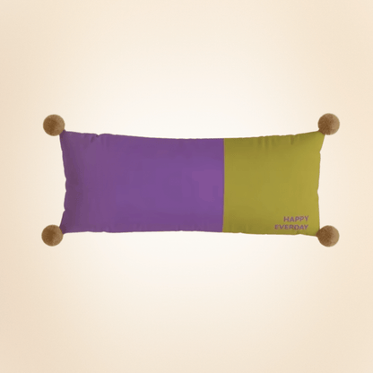 Color-blocked pillow with purple and green sections on a beige background
