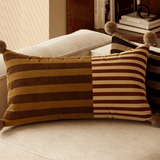Decorative striped pillow on a sofa with a blurred background