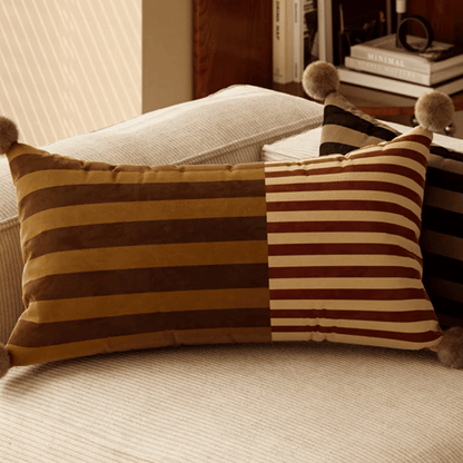 Decorative striped pillow on a sofa with a blurred background