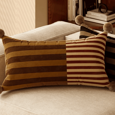 Decorative striped pillow on a sofa with a blurred background