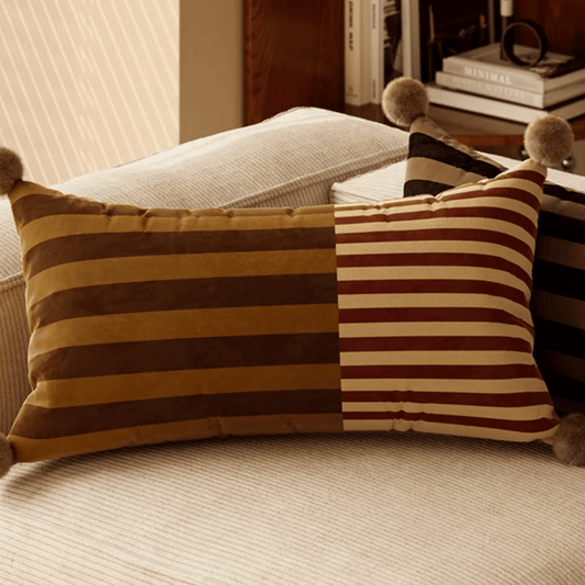 Decorative striped pillow on a sofa with a blurred background
