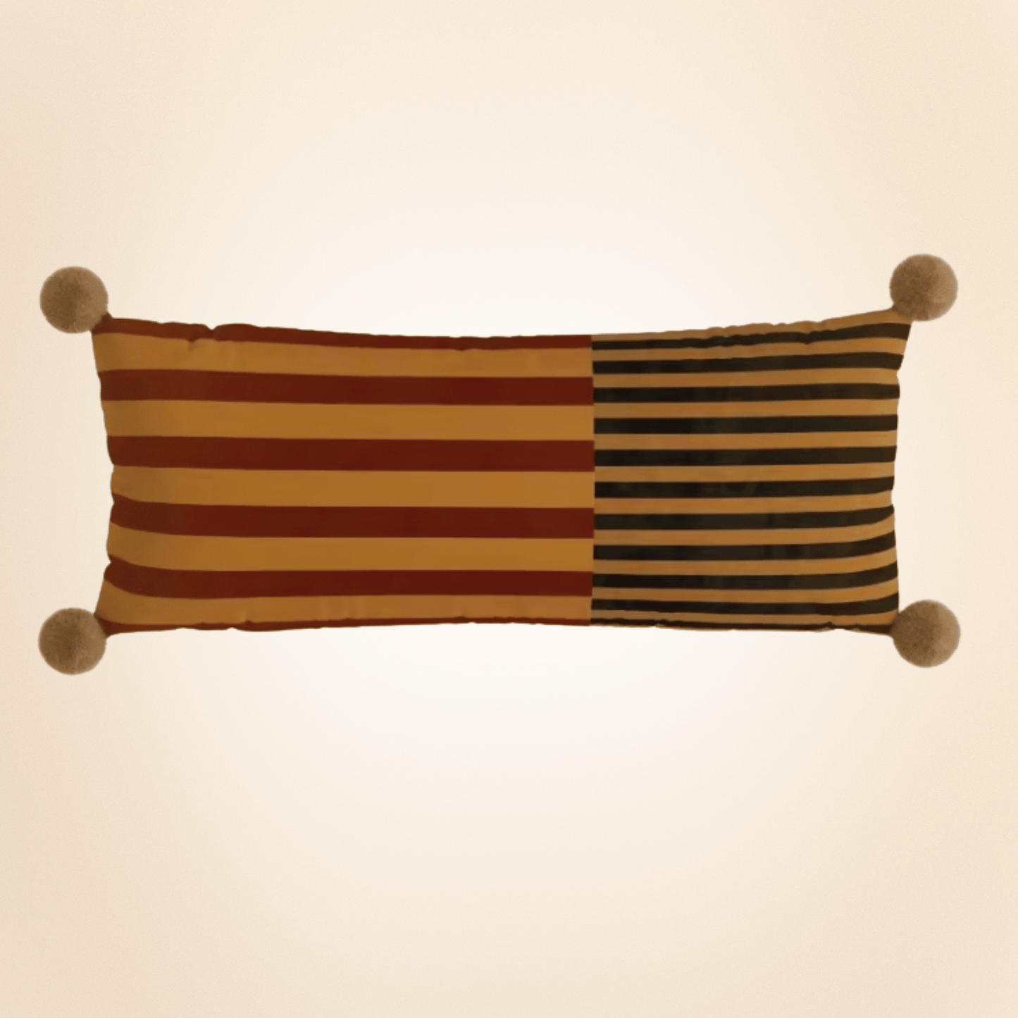 Striped pillow with pom-pom ends on a beige background