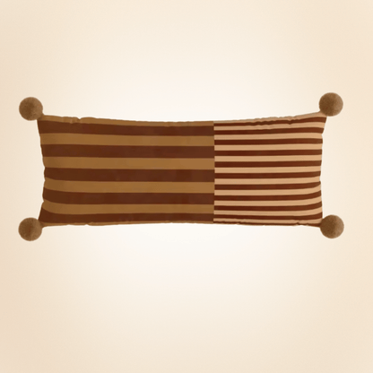 Rectangular pillow with brown and beige stripes on a beige background
