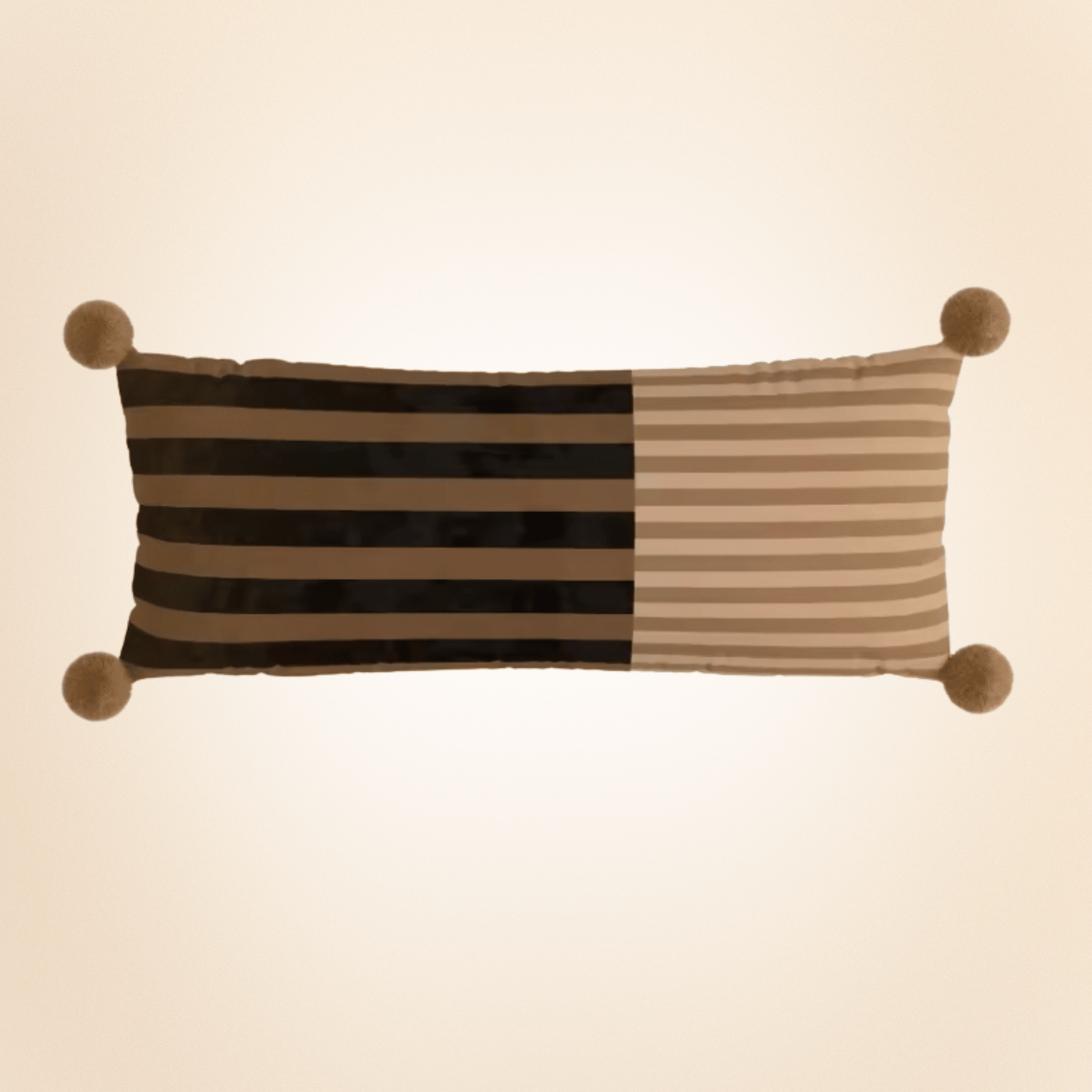 Striped pillow with pom-pom accents on a beige background