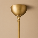 Gold ceiling light fixture against a beige background