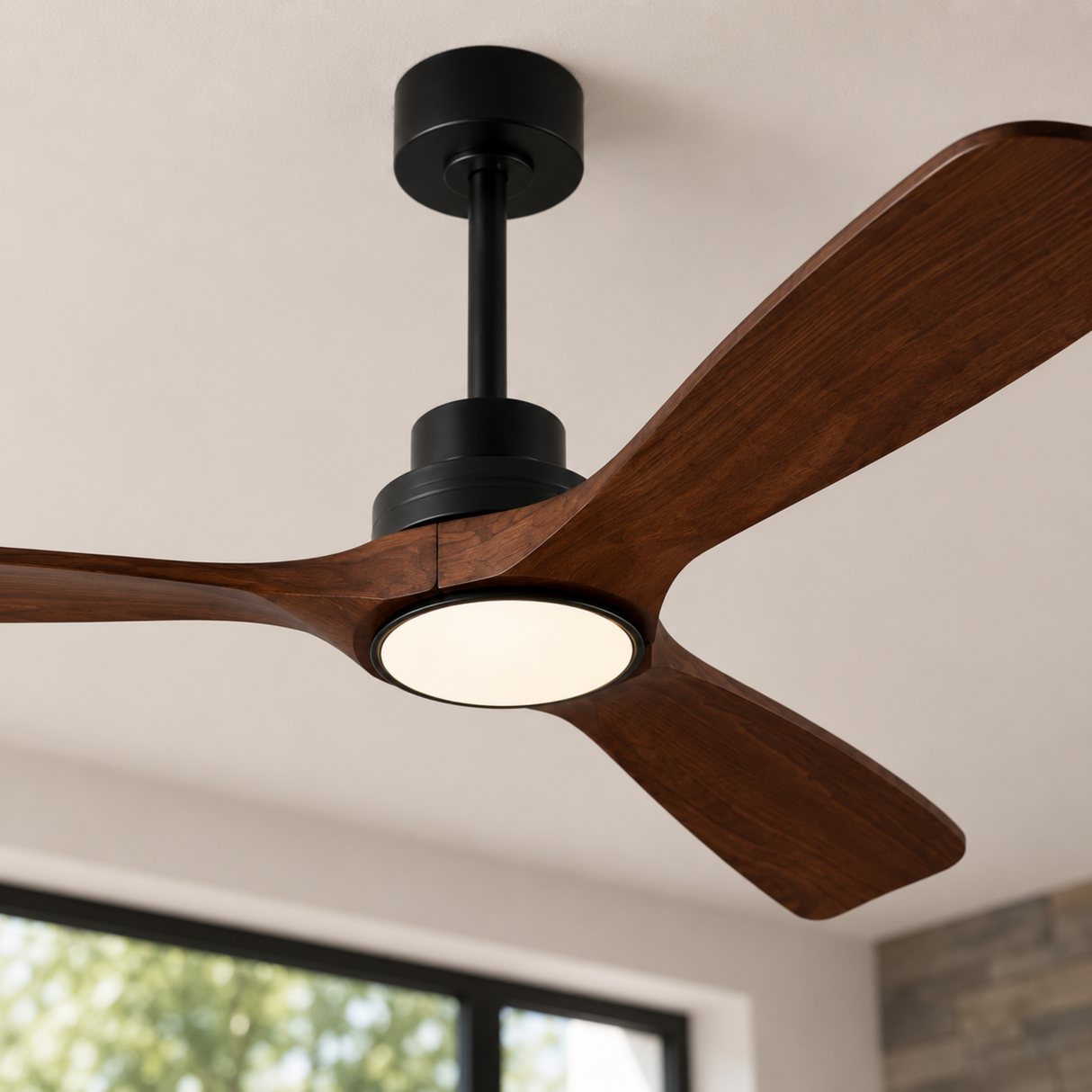 Ceiling fan with wooden blades and black motor housing in a room with a window.