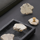 Decorative stones with gold accents on a dark surface