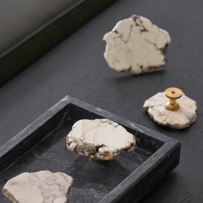 Decorative stones with gold accents on a dark surface