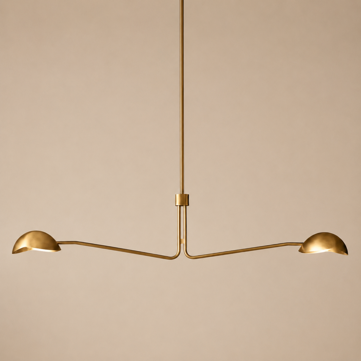 Gold pendant light fixture on a beige background