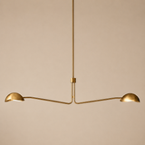 Gold pendant light fixture on a beige background