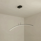 Modern pendant light fixture hanging from the ceiling in a minimalistic room.